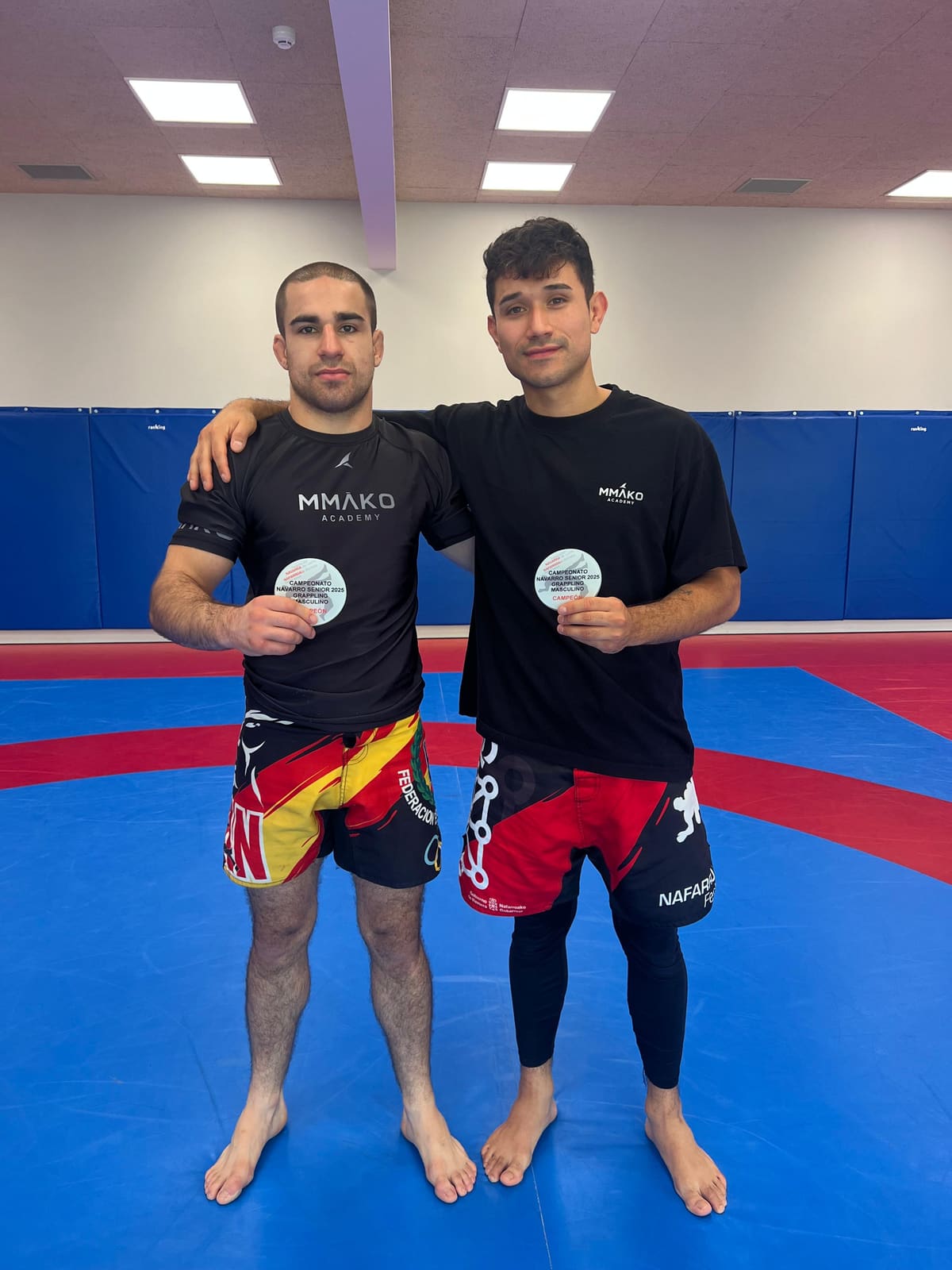 Two team members with their Navarra grappling championship medals