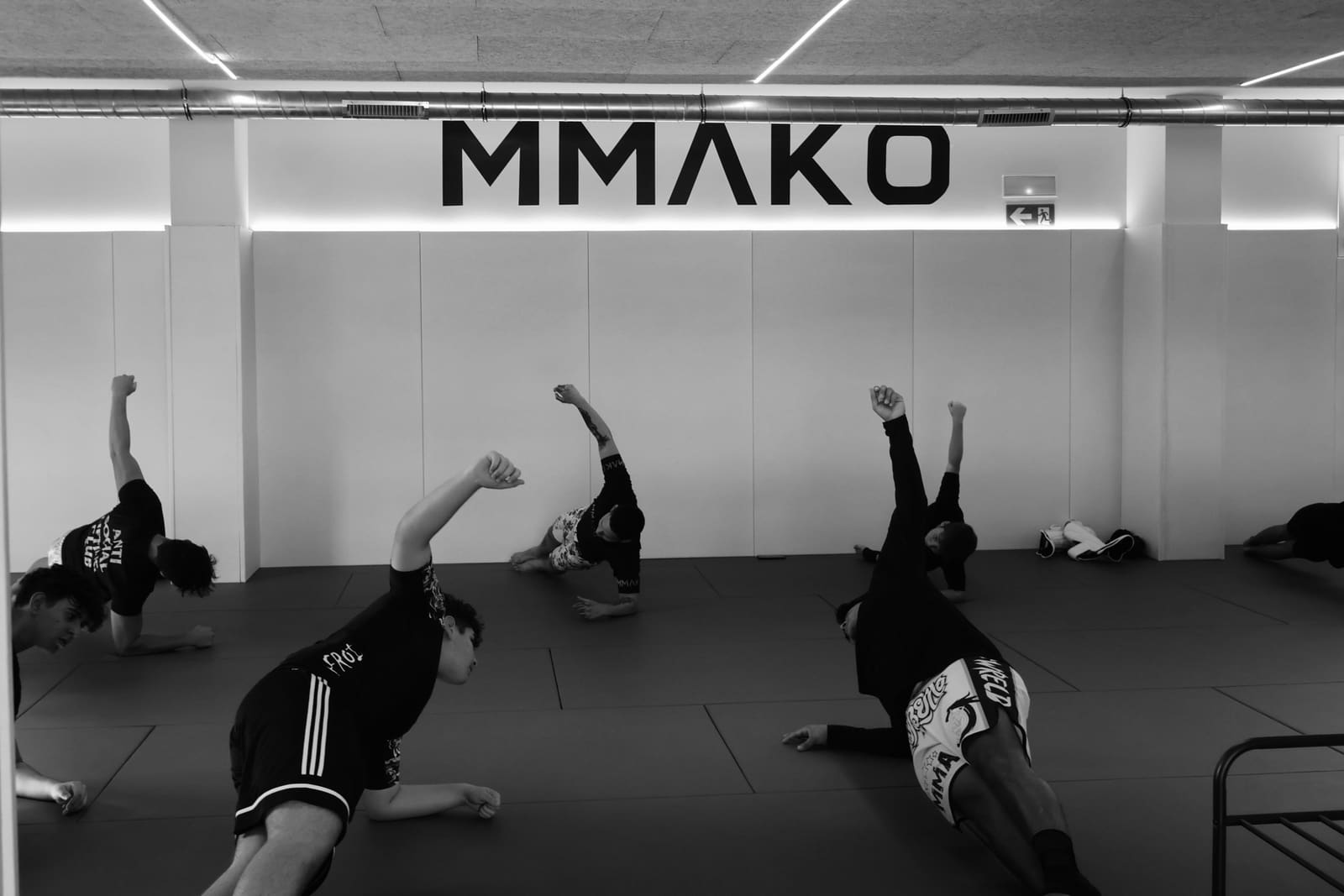 Members doing warm-up exercises on the mats