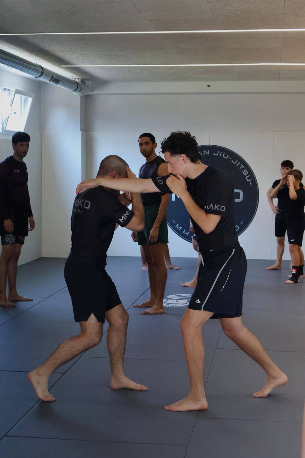 Two members drilling standing techniques during a class